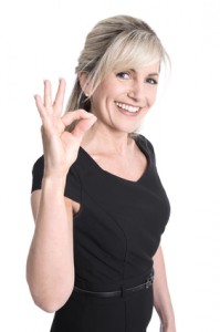 Charming older business woman making excellent symbol with finge